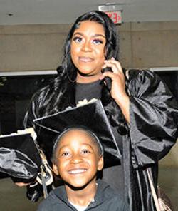 MCC graduate with her child at 2023 commencement